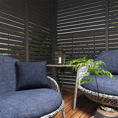 2 chairs with a table and a plant with a background of aluminum emperor pergola sides in a corner