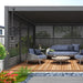 emperor pergola with back and sides covered in the aluminum side panels, with a 3 piece furniture and table set up on wooden decking. 